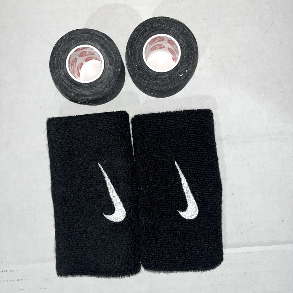 Two Nike wrist bands and two rolls of kinetic tape NWOT